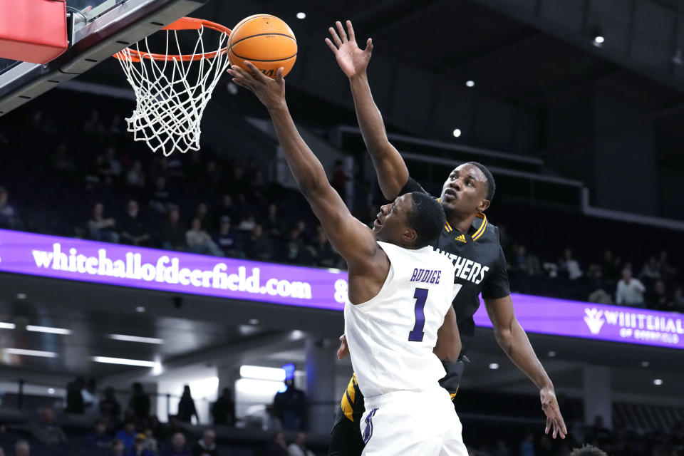Northwestern guard Chase Audige (1) drives to the basket as Prairie View A&M guard Hegel Augustin guards during the second half of an NCAA college basketball game in Evanston, Ill., Sunday, Dec. 11, 2022. Northwestern won 61-51. (AP Photo/Nam Y. Huh)
