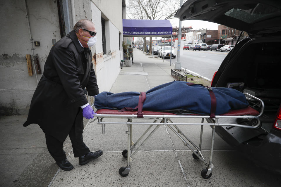 Image: Funeral director collects a body from a nursing home in New York (John Minchillo / AP file)