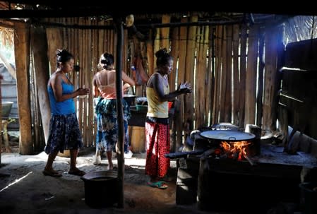 Women cook during a temporary state of siege, approved by the Guatemalan Congress following the death of several soldiers last week, in the community of Semuy II, Izabal province