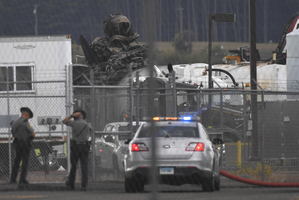 Connecticut State Police stand outside the area of the wreckage of a World War II-era B-17 bomber plane that crashed at Bradley International Airport in Windsor Locks, Conn., Wednesday, Oct. 2, 2019. (AP Photo/Jessica Hill)