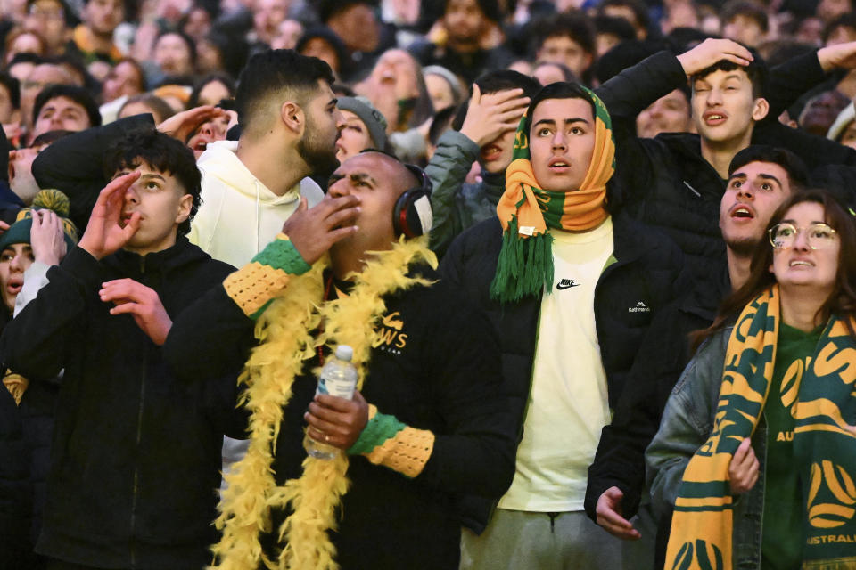 Australia supporters react as they watch a live screening of the Women's World Cup semifinal soccer match between Australia and England at Stadium Australia in Sydney, as they gather at Federation Square in Melbourne, Australia, Wednesday, Aug. 16, 2023. (Joel Carrett/AAP Image via AP)