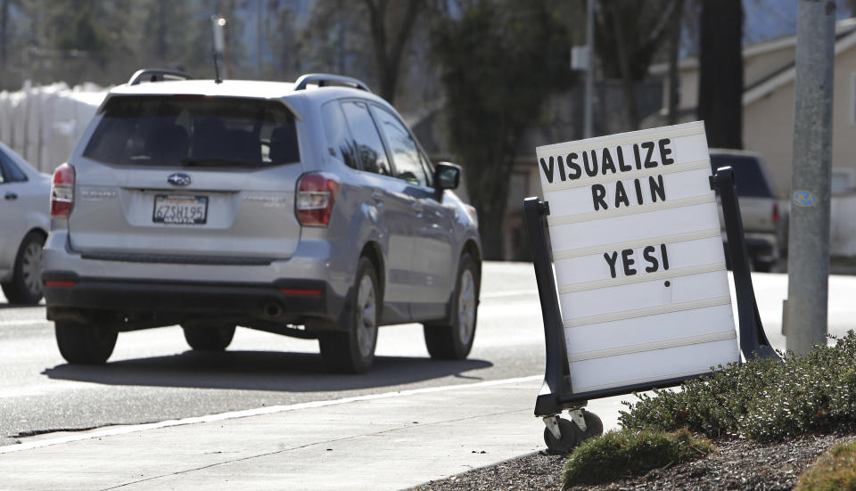 FILE - In this Feb. 4, 2014 file photo, cars drive past a sign outside of a market reminding residents about the short water supply in Willits, Calif. State public health officials have reduced the number of communities at risk of losing their drinking water due to California's drought from 17 to 3. In the Mendocino County town of Willits, which was two months from losing its drinking water, well drilling efforts and rain have helped officials ease restrictions. (AP Photo/Rich Pedroncelli, file)
