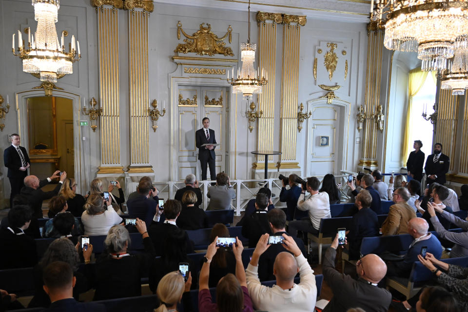 Permanent Secretary of the Swedish Academy Mats Malm, center, announces the 2022 Nobel Prize in Literature, in Borshuset, Stockholm, Sweden, Thursday, Oct. 6, 2022. The 2022 Nobel Prize in literature was awarded to French author Annie Ernaux, for “the courage and clinical acuity with which she uncovers the roots, estrangements and collective restraints of personal memory,” the Nobel committee said. (Henrik Montgomery/TT News Agency via AP)