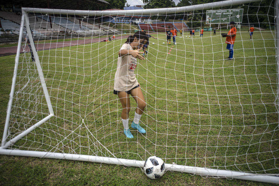 Gabriela Alfonso Cabrera trains at the Pedro Marrero stadium in Havana, Cuba, Wednesday, Sept. 14, 2022. Alfonso sometimes is still the only girl playing alongside boys who are bigger and stronger than her, but she is not quitting after having waited four years to share a field with them. (AP Photo/Ramon Espinosa)