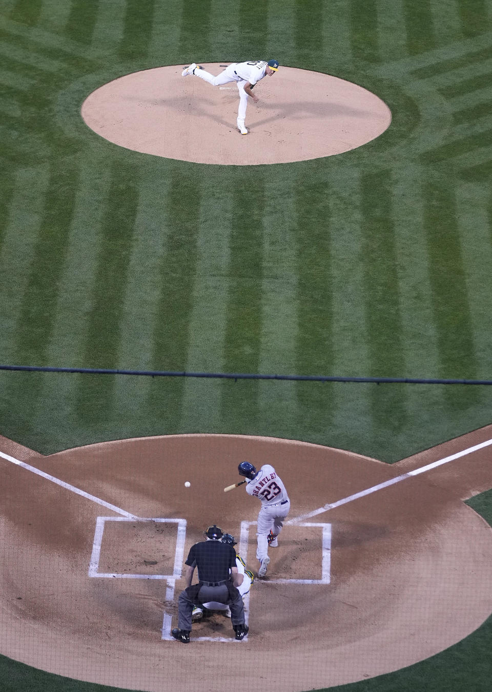 Oakland Athletics pitcher Chris Bassitt (40) works against the Houston Astros' Michael Brantley (23) in the first inning of an opening day baseball game Oakland, Calif., Thursday, April 1, 2021. (AP Photo/Tony Avelar)