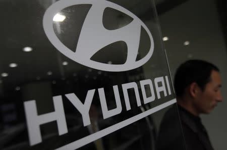 A visitor walks past a Hyundai Motor logo at a Hyundai dealership in Seoul April 25, 2013. REUTERS/Kim Hong-Ji