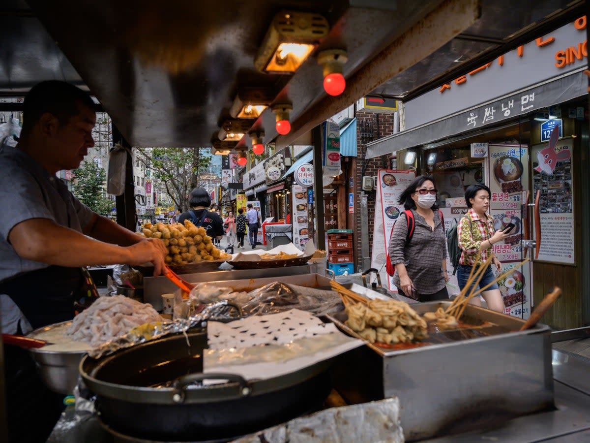 Representational image: A snack vendor prepares food at a stall on a street in Seoul  (AFP via Getty Images)