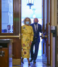 Sen. Mark Kelly, D-Ariz., is joined by Cindy McCain, left, the widow of the late Senator John McCain of Arizona, as Kelly arrives to deliver his maiden speech to the Senate, at the Capitol in Washington, Wednesday, Aug. 4, 2021. (AP Photo/J. Scott Applewhite)