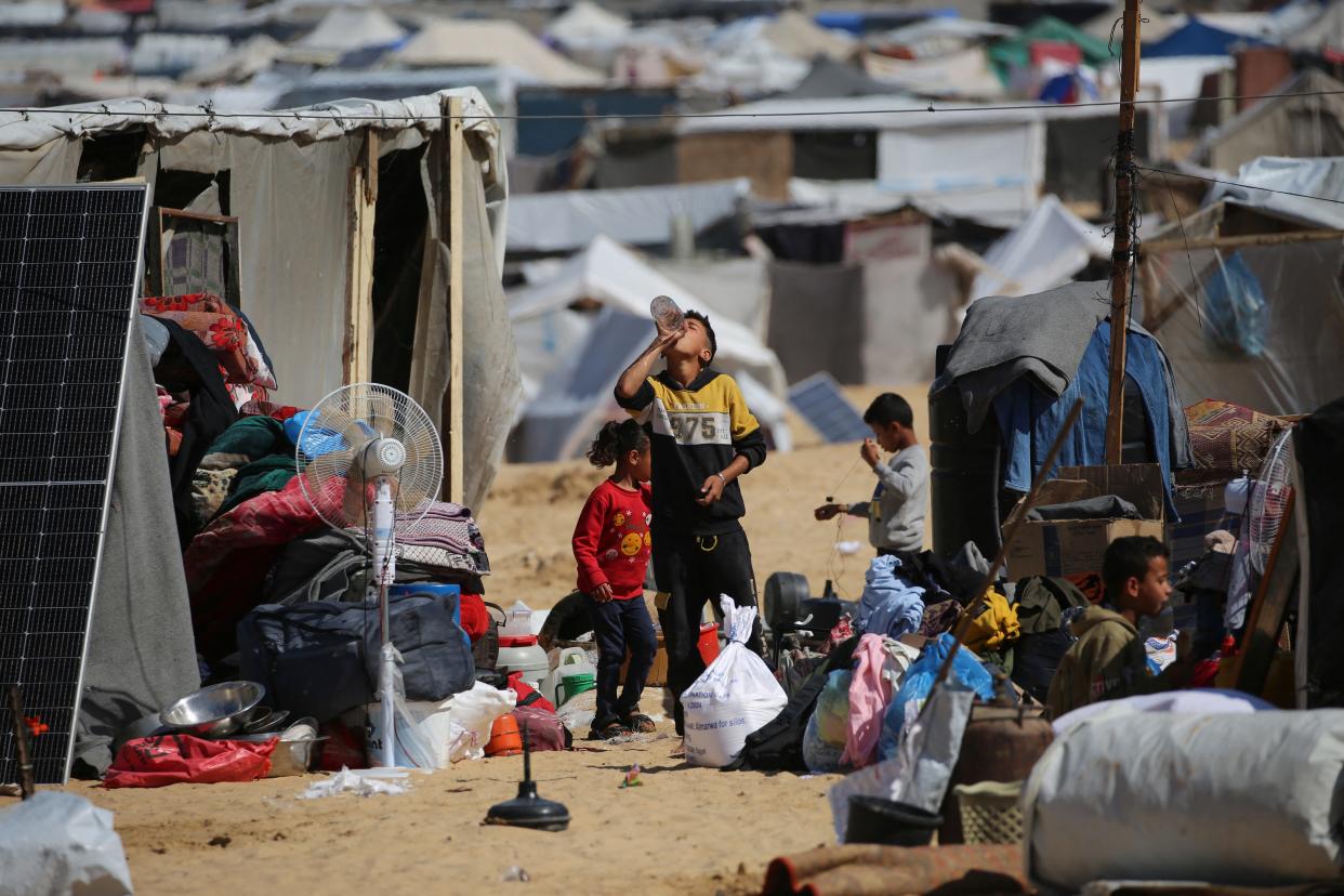 Displaced Palestinians gather their belongings before fleeing to a safer area in Rafah in the southern Gaza Strip on Thursday.