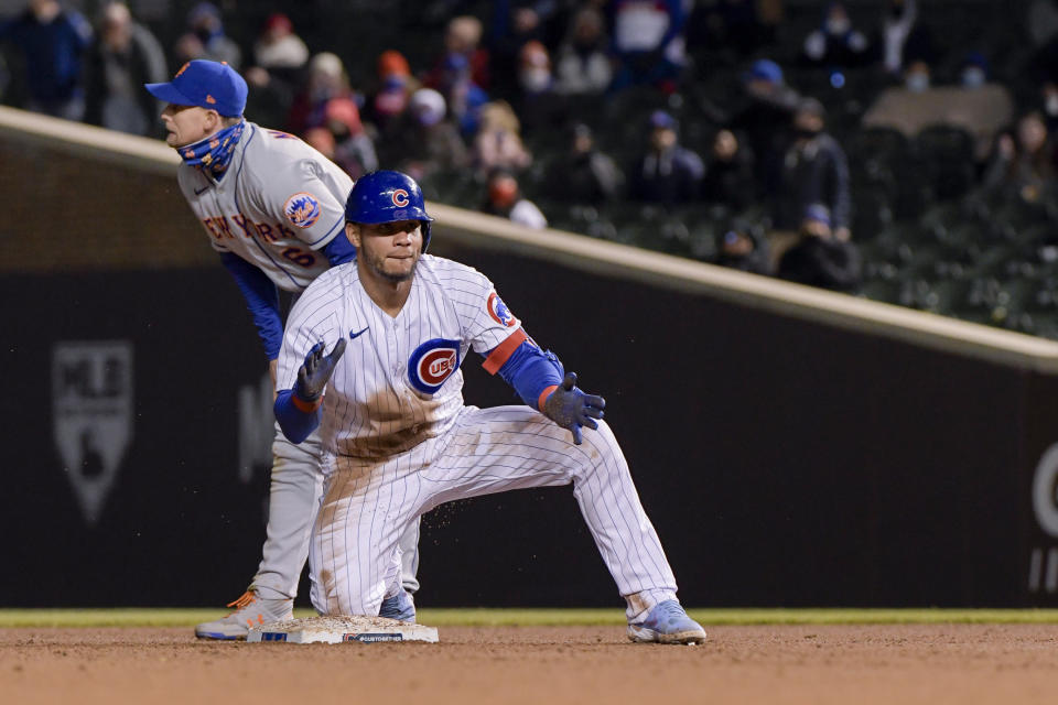 Chicago Cubs Willson Contreras (40) celebrates diving safely into second against the New York Mets during the fifth inning of a baseball game Wednesday, April 21, 2021, in Chicago. (AP Photo/Mark Black)