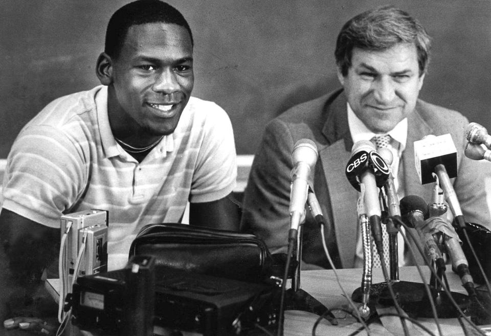 FILE - North Carolina guard Michael Jordan, left, and Tar Heels coach Dean Smith are shown at a news conference in Chapel Hill, N.C., May 5, 1984. Jordan announced he would forfeit his final year of college eligibility to turn pro. (AP Photo/File)