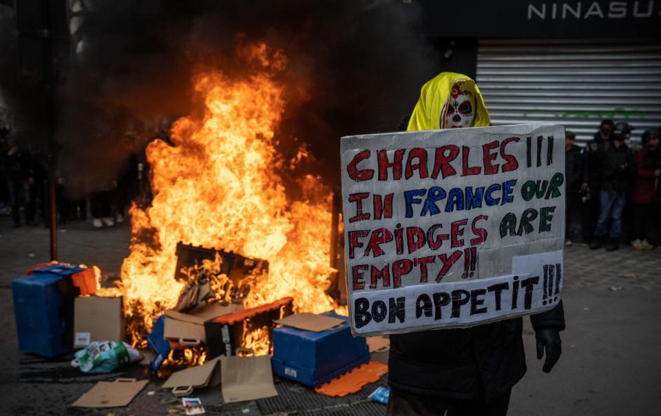 A protester has a warning for the King at a rally in Paris on Tuesday night - GETTY IMAGES