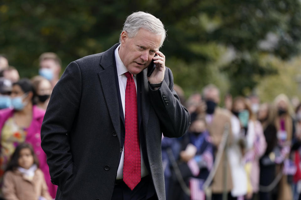 In this Oct. 30, 2020, photo, White House chief of staff Mark Meadows speaks on a phone on the South Lawn of the White House in Washington. Meadows has been diagnosed with the coronavirus as the nation sets daily records for confirmed cases for the pandemic. (AP Photo/Patrick Semansky)