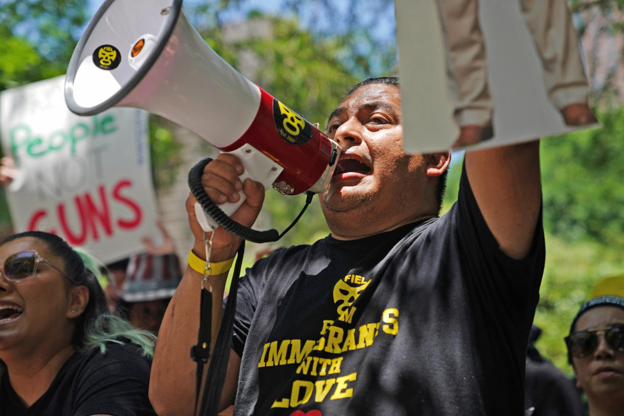 Alain Cisneros protests outside the annual NRA meeting Friday in Houston.  (Allison Dinner for NBC News)