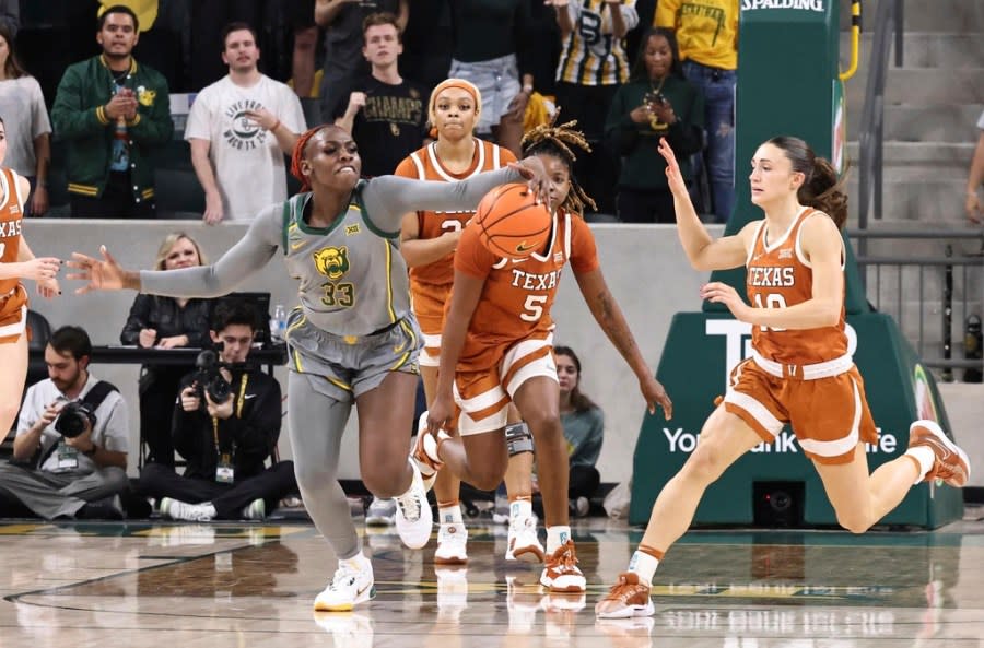 Baylor guard Aijha Blackwell (33) pulls in a loose ball over Texas forward DeYona Gaston (5) and guard Shay Holle, right, in the first half of an NCAA college basketball game, Thursday, Feb. 1, 2024, in Waco, Texas. (Rod Aydelotte/Waco Tribune-Herald via AP)