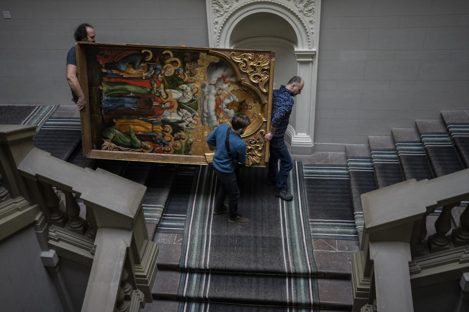 Workers move the Annunciation to the Blessed Virgin of the Bohorodchany Iconostasis in the Andrey Sheptytsky National Museum as part of safety preparations in the event of an attack in the western Ukrainian city of Lviv, Friday, March 4, 2022. The doors of the museum have been closed since Russia’s war on Ukraine began on Feb. 24. (AP Photo/Bernat Armangue)