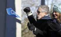 Seattle Seahawks coach Pete Carroll pumps his fist toward spectators at a parade for the NFL football Super Bowl champions Wednesday, Feb. 5, 2014, in Seattle. The Seahawks defeated the Denver Broncos 43-8 on Sunday. (AP Photo/Elaine Thompson)