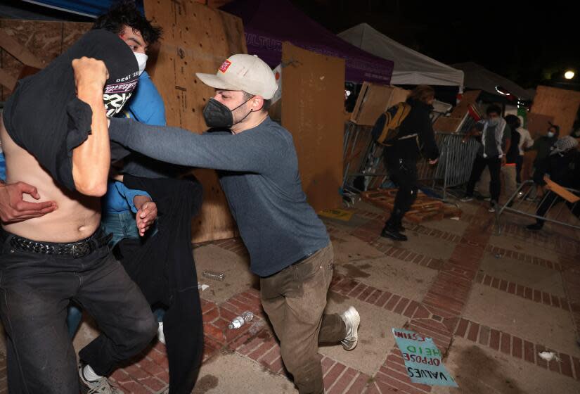 LOS ANGELES, CALIFORNIA - May 1: Pro-Palestinian protestors and pro-Israeli supporters clash at an encampment at UCLA early Wednesday morning. (Wally Skalij/Los Angeles Times)