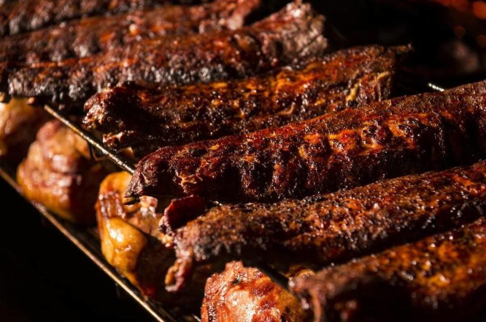 Ribs cook on a smoker carousel at the Freight House location of Fiorella’s Jack Stack Barbecue in Kansas City.