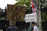 Brexit supporters holds placards as they protest outside the Houses of Parliament in London, Tuesday, June 18, 2019. All six contenders to replace British Prime Minister Theresa May as leader of the ruling Conservative party vow they will succeed where May failed and lead Britain out of the European Union, though they differ about how they plan to break the country's Brexit deadlock. (AP Photo/Matt Dunham)