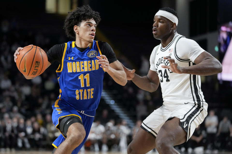 Morehead State's Trent Scott (11) drives against Vanderbilt forward Lee Dort (34) in the second half of an NCAA college basketball game Friday, Nov. 18, 2022, in Nashville, Tenn. (AP Photo/Mark Humphrey)