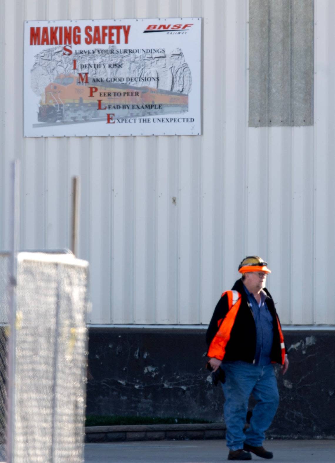 A railroad worker walked past a sign promoting safe working practices at the BNSF Railway Argentine Yard in Kansas City, Kansas.