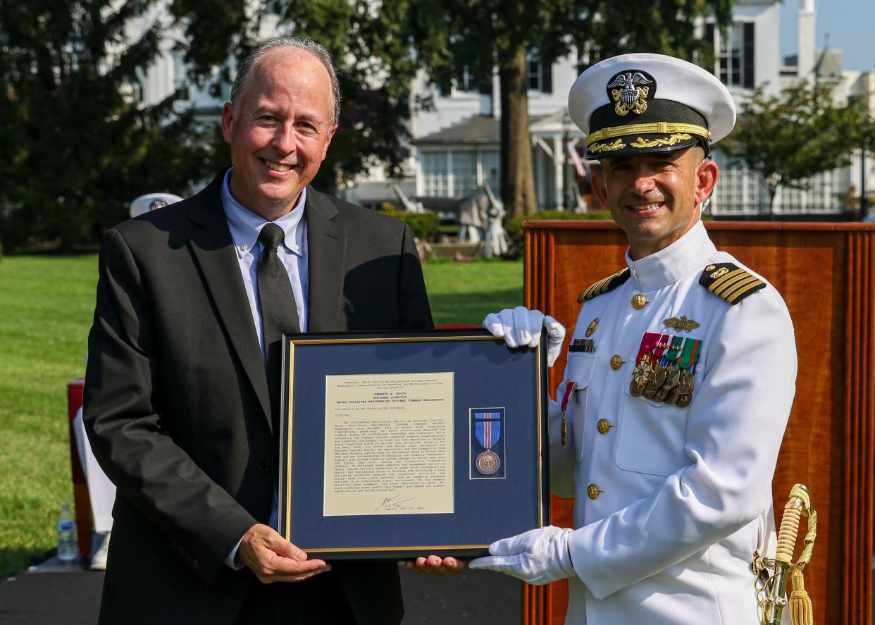 Kenneth Booth, an Olyphant, Penn. native (left), was awarded the Meritorious Civilian Service award by Capt. Gregory G. Vinci (right) for outstanding meritorious service while serving as Naval Facilities Engineering Systems Command (NAVFAC) Washington business director from December 2012 to August 2021 during NAVFAC Washington’s change of command ceremony