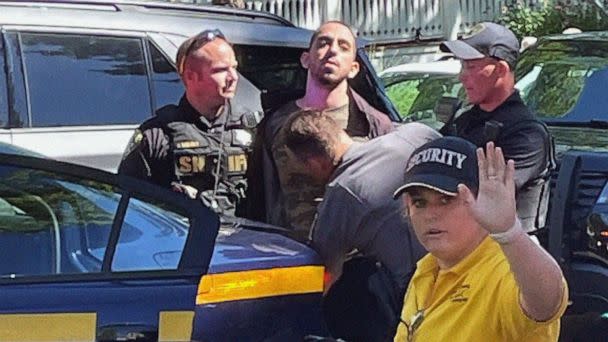 PHOTO: Law enforcement officers detain a person outside the Chautauqua Institution, in Chautauqua, N.Y., Aug. 12, 2022. Author Salman Rushdie was attacked by a man who rushed the stage, as Rushdie was about to give a lecture at the institute. (Charles Fox/AP)