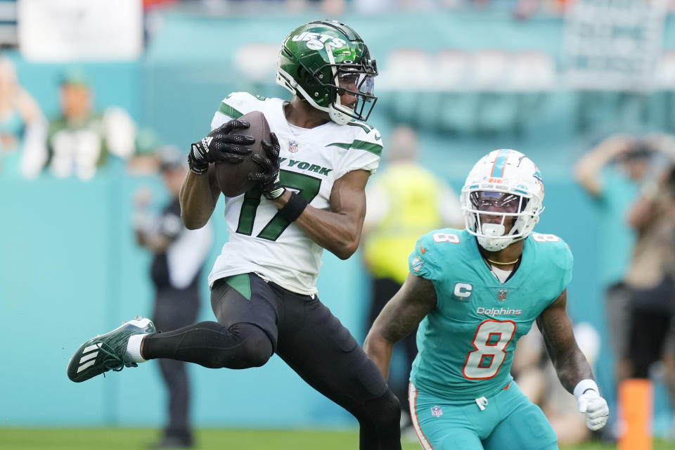 New York Jets wide receiver Garrett Wilson (17) grabs a pass in front of Miami Dolphins safety Jevon Holland (8) during the second half of an NFL football game, Sunday, Jan. 8, 2023, in Miami Gardens, Fla. (AP Photo/Rebecca Blackwell)