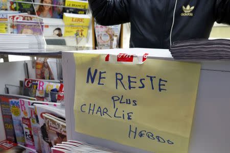 A handwritten sign at a newsstand, which reads "No more Charlie Hebdo", is displayed after it sold out the limited stock of the satirical newspaper in Paris January 14, 2015. REUTERS/John Schults