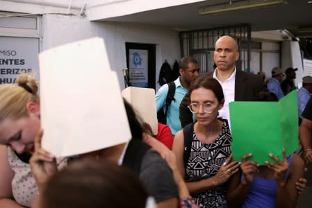 U.S. Senator (D-NJ) Cory Booker escorts migrants seeking asylum towards El Paso, Texas, U.S., as seen at Paso del Norte border crossing bridge in Ciudad Juarez