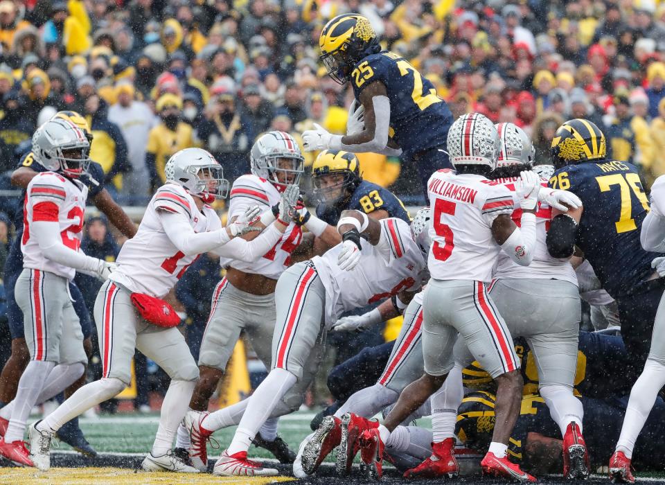 Michigan running back Hassan Haskins scores a touchdown against Ohio State during the first half at Michigan Stadium in Ann Arbor on Saturday, Nov. 27, 2021.