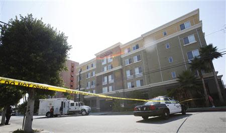 A Sheriff's Department Bomb Squad truck and a police patrol car are parked outside the apartment complex of suspect Nna Alpha Onuoha in Inglewood, California September 11, 2013. REUTERS/Mario Anzuoni