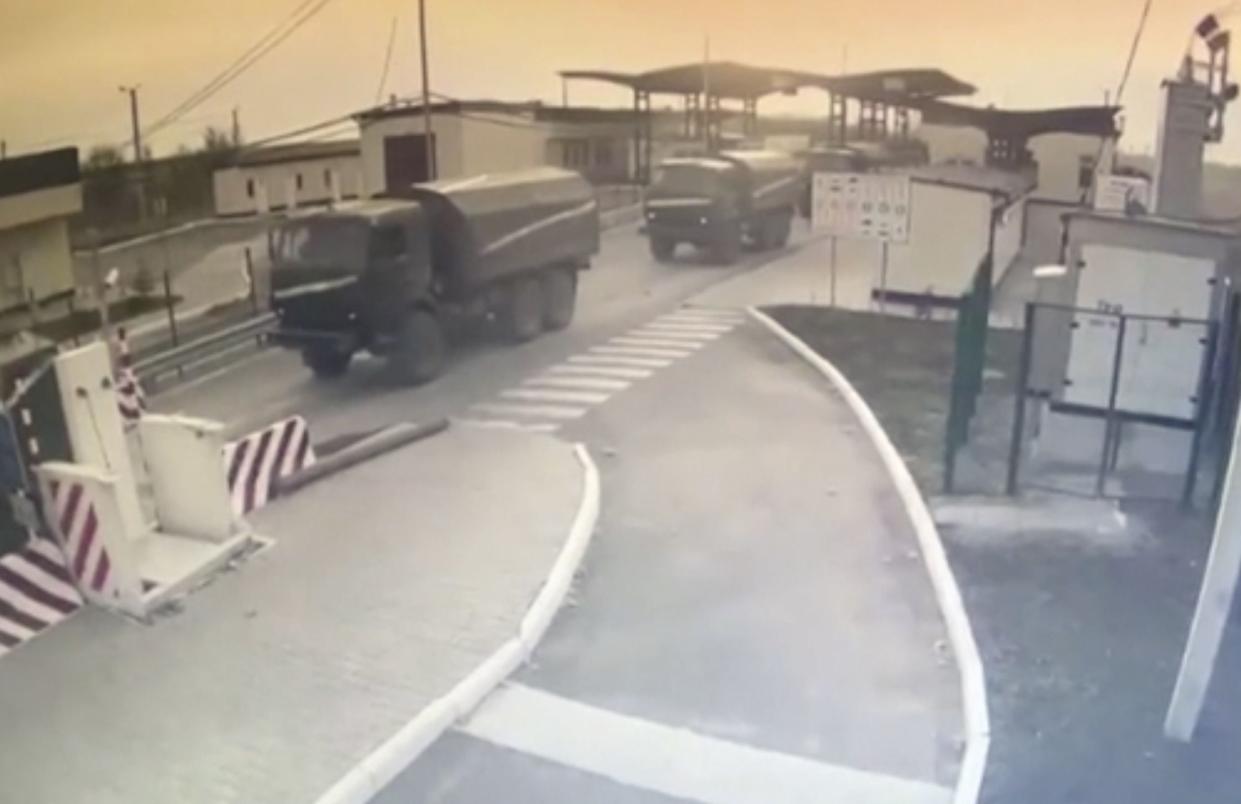 In this image made from video provided by the Border Service of Ukraine, military vehicles pass a control point at the Armyansk checkpoint at the Ukraine-Crimea border, Thursday, Feb. 24, 2022. The Ukrainian border service on Thursday released video it said showed Russian military vehicles crossing its border from Crimea. In a statement, it added that "the movement of military equipment from the peninsula is being recorded across the administrative border".
