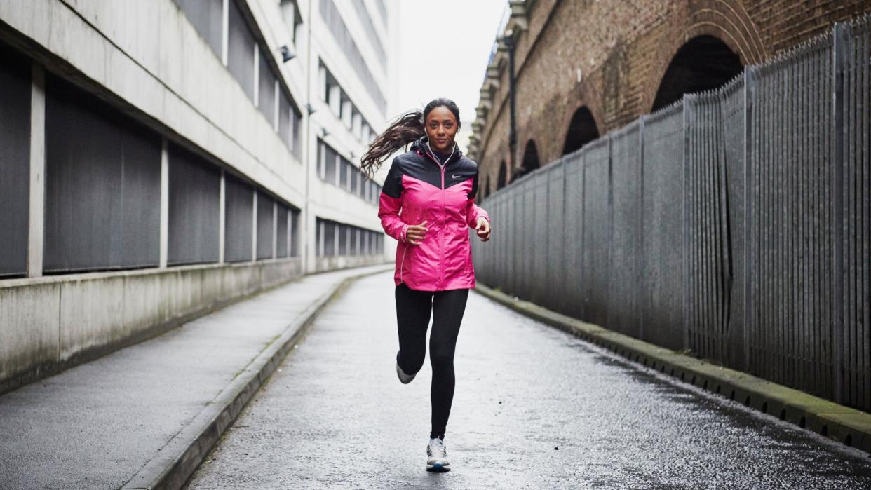  A woman running through an urban area. 