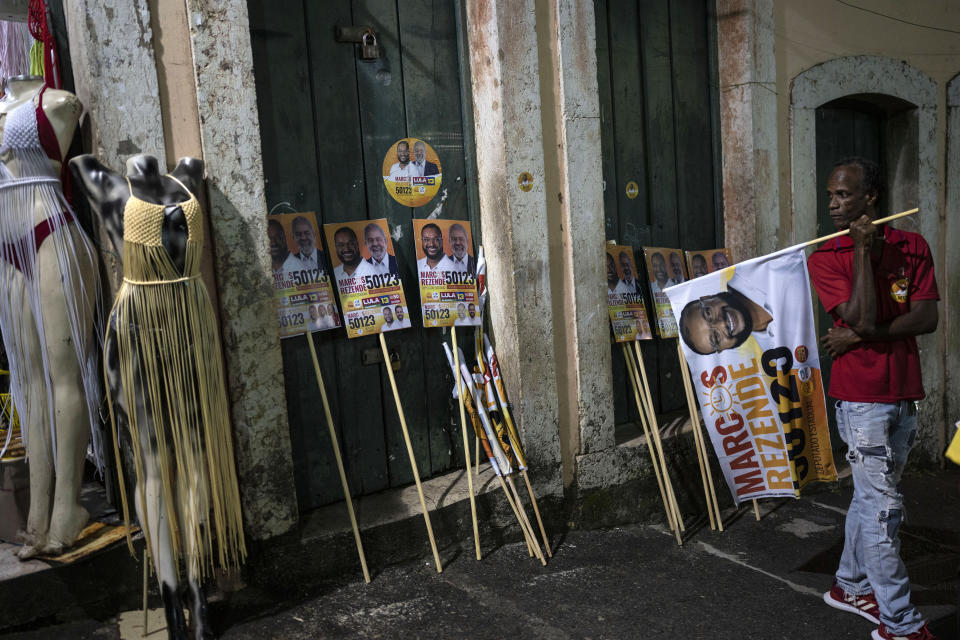 Electoral posters promoting candidate Marcos Rezende and former President Luiz Inacio Lula da Silva, who is running for president, are propped against a wall, during a Worker's Party campaign rally in the Pelourinho neighborhood of Salvador, Brazil, Tuesday, Sept. 13, 2022. The man Brazilians know as Lula leads in all polls against incumbent President Jair Bolsonaro ahead of the Oct. 2 election. Those same polls have shown Bolsonaro has strong support among evangelical voters. (AP Photo/Rodrigo Abd)