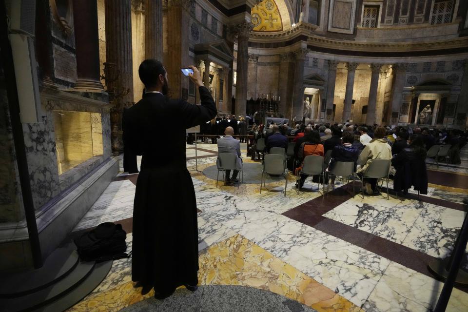 Faithfuls watch during a Latin Mass at Rome's ancient Pantheon basilica, in Rome, Italy, Friday, Oct. 29, 2021. Traditionalist Catholics descended on Rome on Friday for their annual pilgrimage, hoping to show the vibrancy of their community after Pope Francis issued a crackdown on the spread of the Latin Mass that many took as an attack on the ancient rite. An evening vespers service at Rome's ancient Pantheon basilica, the first event of the three-day pilgrimage, was so full that ushers had to add two rows of chairs to accommodate the faithful. Many young families, couples and priests filled the pews, hailing from the U.S., France, Spain and beyond. (AP Photo/Luca Bruno)