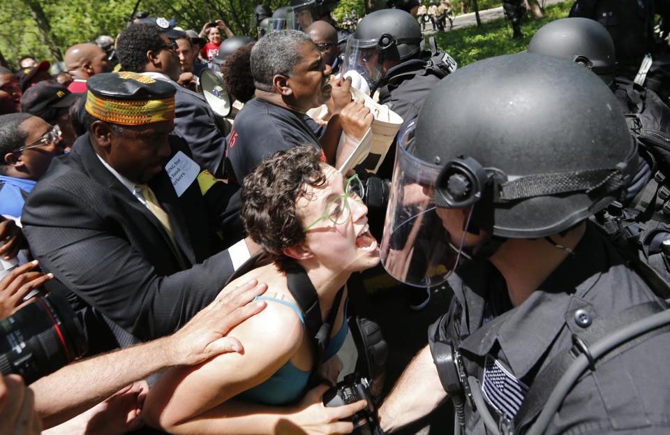 Demonstrators clash with police during a protest at McDonald's headquarters in Oak Brook, Illinois, May 21, 2014. The Workers Organizing Committee of Chicago’s Fight for 15 said in a statement that restaurant workers have held strikes and protests six times in the last 1 1/2 years challenging the company’s median wage of $8.94. The Wednesday protest is a preview of what the group said it plans for Thursday’s annual stockholder’s meeting. The company closed one of its five buildings in anticipation of the protests. (REUTERS/Jim Young)