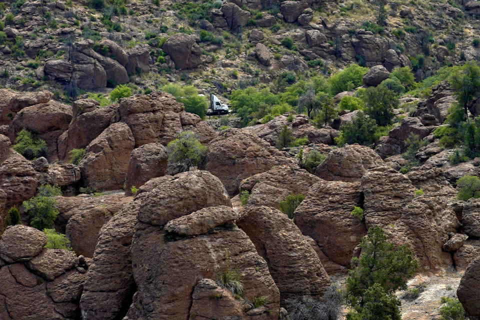 A tractor-trailer carrying supplies to the Resolution Copper Mining Company approaches the mine's main entrance, Friday, June 9, 2023, in Miami, Ariz. (AP Photo/Matt York)