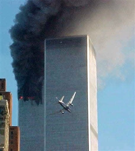 In this Sept. 11, 2001 file photo, a jet airliner is lined up on one of the World Trade Center towers in New York.