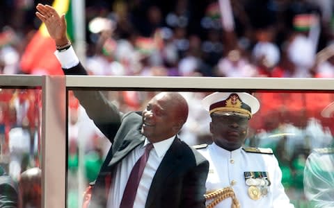 President elect Uhuru Kenyatta, waves to his supporters as he arrives at Moi International Sports Complex in Nairobi - Credit:  Sayyid Abdul Azim/ AP