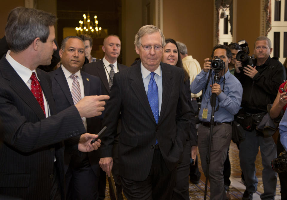 Senate Minority Leader Sen. Mitch McConnell, R-Ky., walks to the Senate floor after agreeing to the framework of a deal to avoid default and reopen the government on Capitol Hill on Wednesday, Oct. 16, 2013 in Washington. (AP Photo/ Carolyn Kaster)