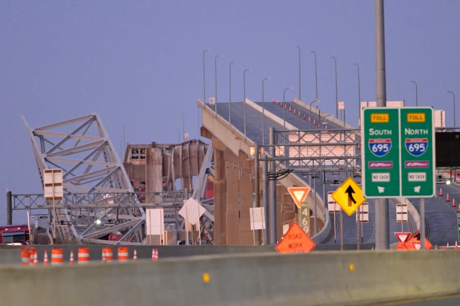 Parts of the Francis Scott Key Bridge remain after a container ship collided with a support Tuesday, March 26, 2024 in Baltimore. The major bridge in Baltimore snapped and collapsed after a container ship rammed into it early Tuesday, and several vehicles fell into the river below. Rescuers were searching for multiple people in the water. (AP Photo/Steve Ruark)