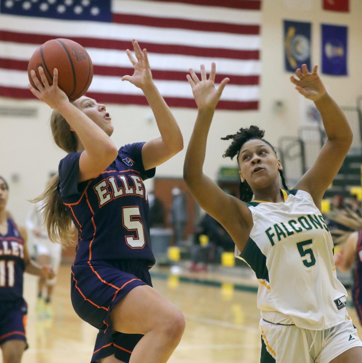 Ellet's Rachel Wenzel drives past Firestone's Brittnyana McCall during Thursday night's City Series game. Ellet won 61-21. [Phil Masturzo/Beacon Journal]