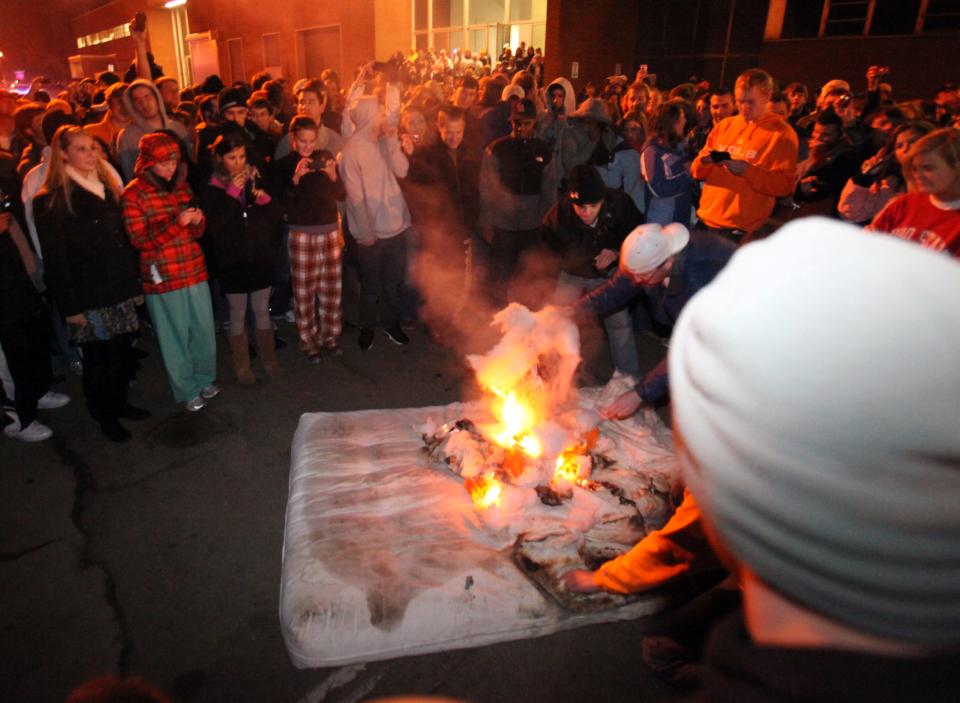 In a Jan. 12, 2010, photograph, students burn a mattress outside the football complex after Lane Kiffin announced his resignation as coach of the University of Tennessee football team. Kiffin took the coaching job at Southern California  after just one season at Tennessee. (Adam Brimer/News Sentinel)




