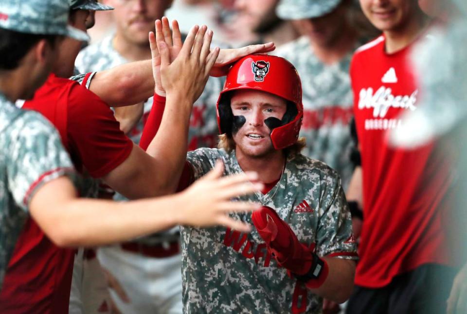 NC State’s Matt Heavner (6) celebrates with his teammates after scoring a run during Game 3 of the Super NCAA Regional against Georgia at Foley Field on Monday, June 10, 2024 in Athens, Ga.