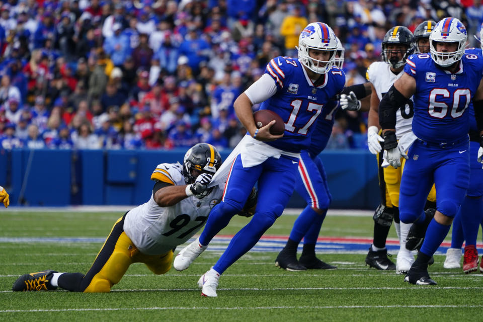 Oct 9, 2022; Orchard Park, New York, USA; Buffalo Bills quarterback <a class="link " href="https://sports.yahoo.com/nfl/players/30977" data-i13n="sec:content-canvas;subsec:anchor_text;elm:context_link" data-ylk="slk:Josh Allen;sec:content-canvas;subsec:anchor_text;elm:context_link;itc:0">Josh Allen</a> (17) runs with the ball with Pittsburgh Steelers defensive tackle <a class="link " href="https://sports.yahoo.com/nfl/players/24818" data-i13n="sec:content-canvas;subsec:anchor_text;elm:context_link" data-ylk="slk:Cameron Heyward;sec:content-canvas;subsec:anchor_text;elm:context_link;itc:0">Cameron Heyward</a> (97) defending during the first half at Highmark Stadium. Mandatory Credit: Gregory Fisher-USA TODAY Sports
