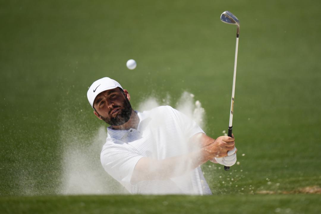 Scottie Scheffler hits out of the bunker on the second hole during third round at the Masters golf tournament at Augusta National Golf Club Saturday, April 13, 2024, in Augusta, Ga. (AP Photo/Matt Slocum)
