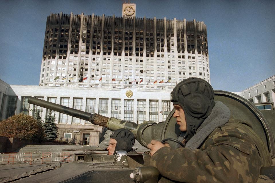 FILE - Russian army soldiers sit in a tank waiting for orders to leave the area near the Russian parliament building in Moscow on Oct. 6, 1993 as the last group of tanks and APC's pulled out from the area of Monday's battle between the pro-Yeltsin supporters and hard-liners. Three decades ago, the world held its breath as tanks blasted the Russian parliament building in central Moscow while the Kremlin moved to flush out rebellious lawmakers in a crisis that shaped the country's post-Soviet history. (AP Photo/Michel Euler, File)