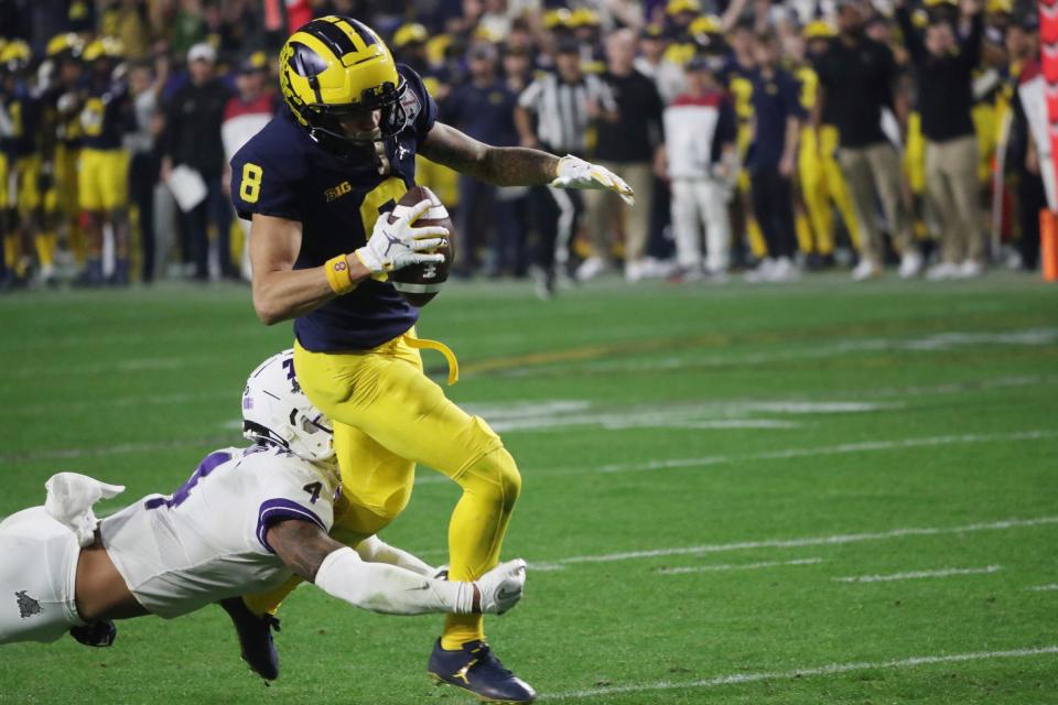 Michigan wide receiver Ronnie Bell (8) attempts to out run TCU safety Namdi Obiazor (4) in the third quarter of the Fiesta Bowl on Saturday, Dec. 31 at State Farm Stadium in Glendale, Ariz.